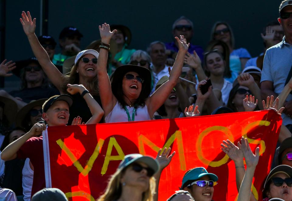 11-year-old Brody Carroll (left) and family cheer for Rafael Nadal as he faces Daniel Evans during round three of the 2022 BNP Paribas Open in Indian Wells.