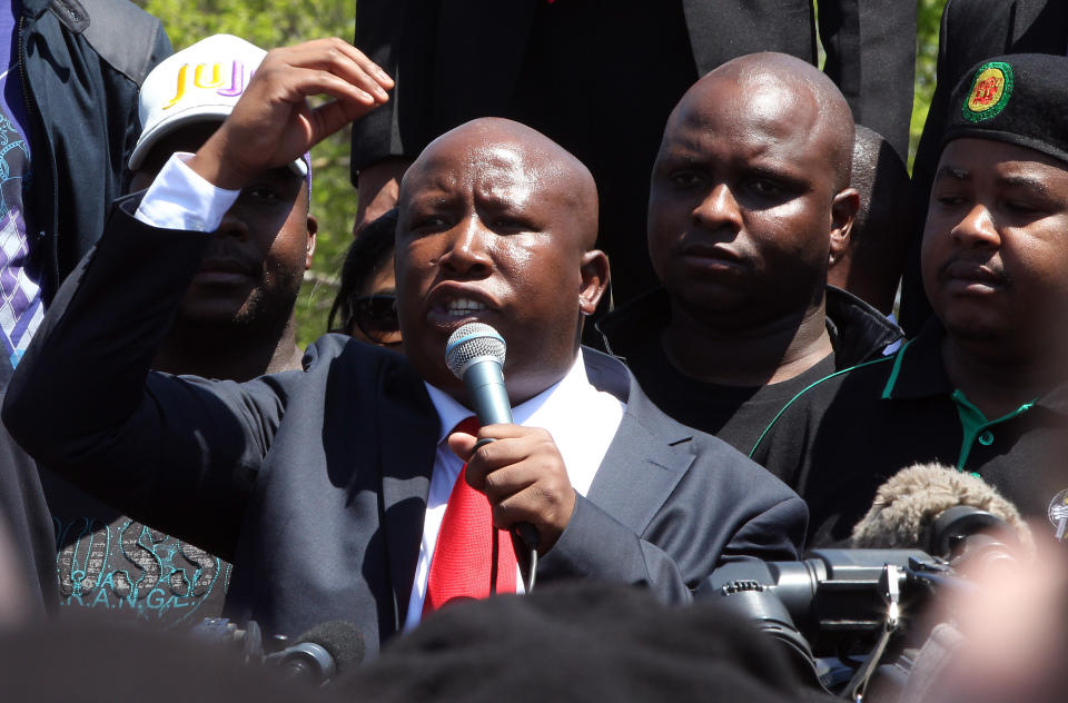 Firebrand politician Julius Malema addresses his supporters after appearing at the Magistrate’s Court in Polokwane, South Africa, Wednesday, Sept. 26, 2012, on charges of money laundering in connection with an improper government tender awarded to a company his family trust partly owns. (AP Photo/Themba Hadebe)