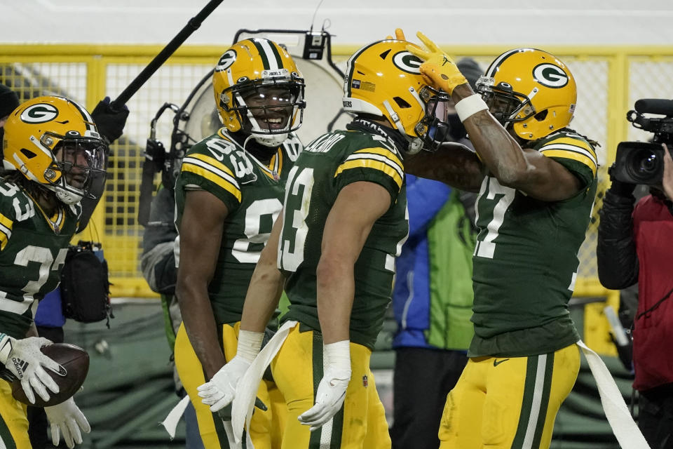 Green Bay Packers' Allen Lazard (13) is congratulated by teammates after scoring on a 58-yard touchdown run during the second half of an NFL divisional playoff football game Saturday, Jan. 16, 2021, in Green Bay, Wis. (AP Photo/Morry Gash)