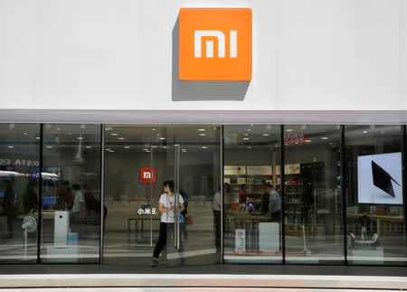 FILE PHOTO: A customer walks out of a Xiaomi store in Beijing, China June 21, 2018. REUTERS/Jason Lee/File Photo