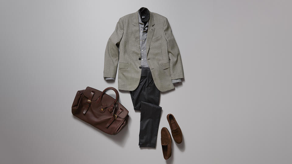 Celine Homme by Hedi Slimane boxy jacket in wool and cashmere, $3,700; Brunello Cucinelli cotton-denim shirt, $995; Dior Men cashmere turtleneck, $1,350; Luca Faloni wool pleated trousers, $250; John Lobb ultra-supple loafers in dark-brown suede, $1,890; Ralph Lauren Purple Label calfskin duffel bag, $4,500.