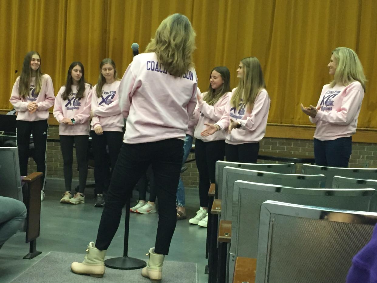 Lexington cross country coach Denise Benson introduces members of her girls squad, which finished eighth at last month's state meet, at Wednesday's school board meeting.
