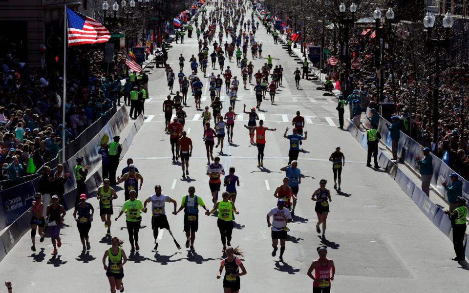 Runners approach the finish line of the 120th Boston Marathon in Boston last year - Credit: AP