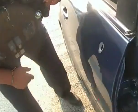 A police officer approaches the bullet-riddled car of George Jensen on May 17 along I-76 in a still image from body camera footage released by the Ohio State Highway Patrol.