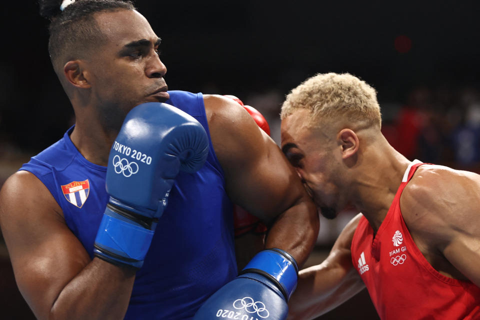 Britain's Benjamin Whittaker (red) and Cuba's Arlen Lopez fight during their men's light heavy (75-81kg) boxing final bout during the Tokyo 2020 Olympic Games at the Kokugikan Arena in Tokyo on August 4, 2021. (Photo by Buda Mendes / POOL / AFP) (Photo by BUDA MENDES/POOL/AFP via Getty Images)