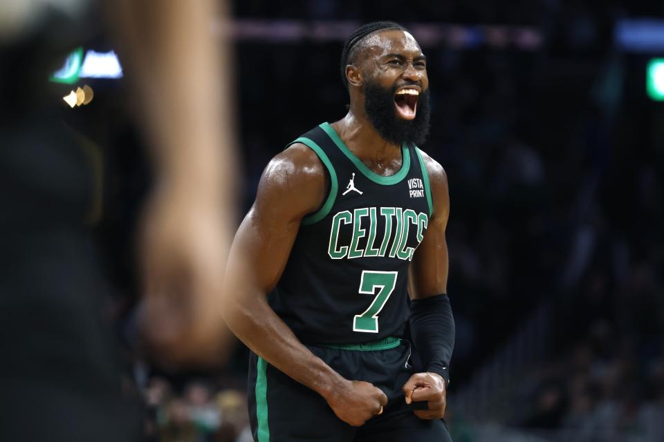 Boston Celtics' Jaylen Brown reacts after scoring against the Orlando Magic during the first half of an NBA basketball game Friday, Dec. 15, 2023, in Boston. (AP Photo/Michael Dwyer)