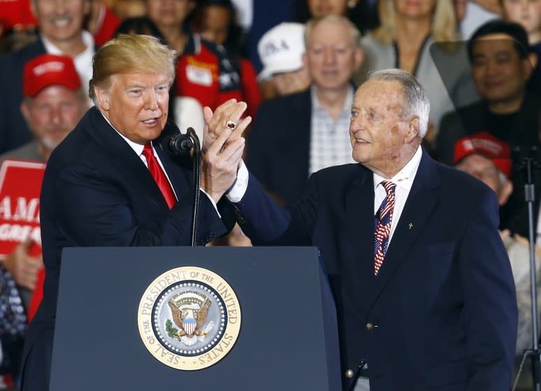 President Donald Trump points to the National Championship ring that Bobby Bowden is wearing after he speaks at a rally, Saturday, Nov. 3, 2018, in Pensacola, Fla. (AP Photo/Butch Dill)