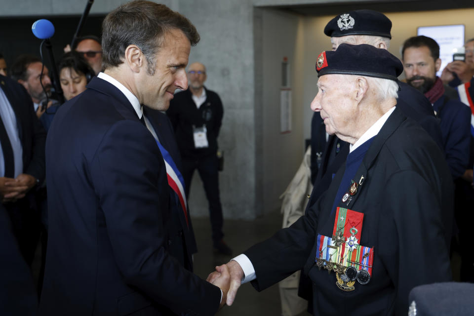 French President Emmanuel Macron shakes hands with British veteran Jack Kuinn during his visit of Arromanches D-Day museum as part of the 79th anniversary of the World War II "D-Day" Normandy landings, in Arromanches, Normandy, Tuesday, June 6, 2023. Dozens of World War II veterans have traveled to Normandy to mark the 79th anniversary of D-Day, the decisive but deadly assault that led to the liberation of France and Western Europe from Nazi control. ( Ludovic Marin, Pool via AP)