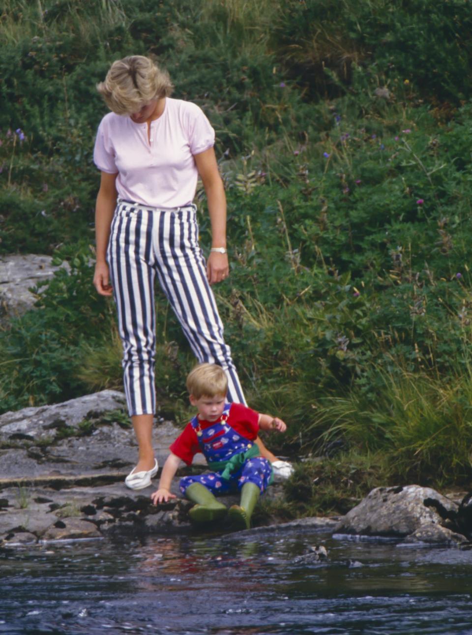 <p>Diana and Harry played on the banks of the River Dee near Balmoral Castle during a summer vacation in August 1987. Diana went for a thicker pinstripe with these denim pedal pushers, completing the look with a tucked-in, baby-pink T-shirt and white leather boat shoes.</p>