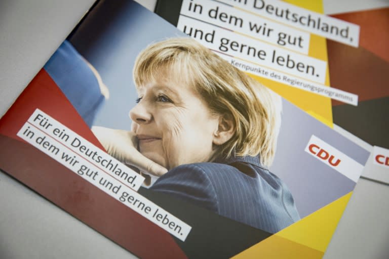 A portrait of German Chancellor and leader of the Christian Democratic Union party (CDU) Angela Merkel is seen on a leaflet at the CDU's headquarters in Berlin, ahead of general elections