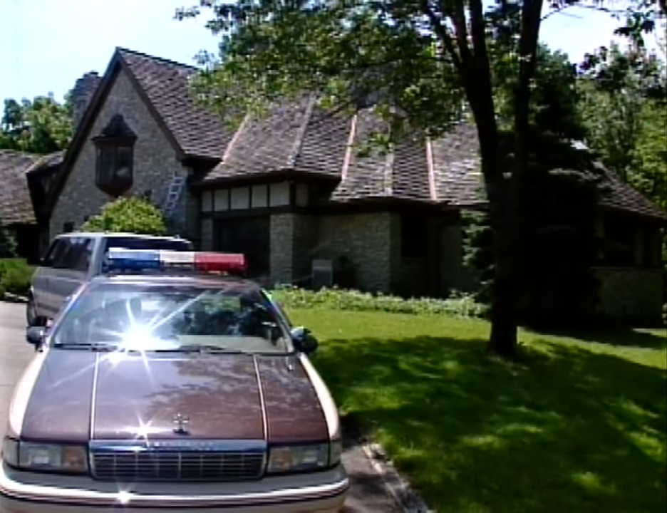 A police car parked outside of a residence