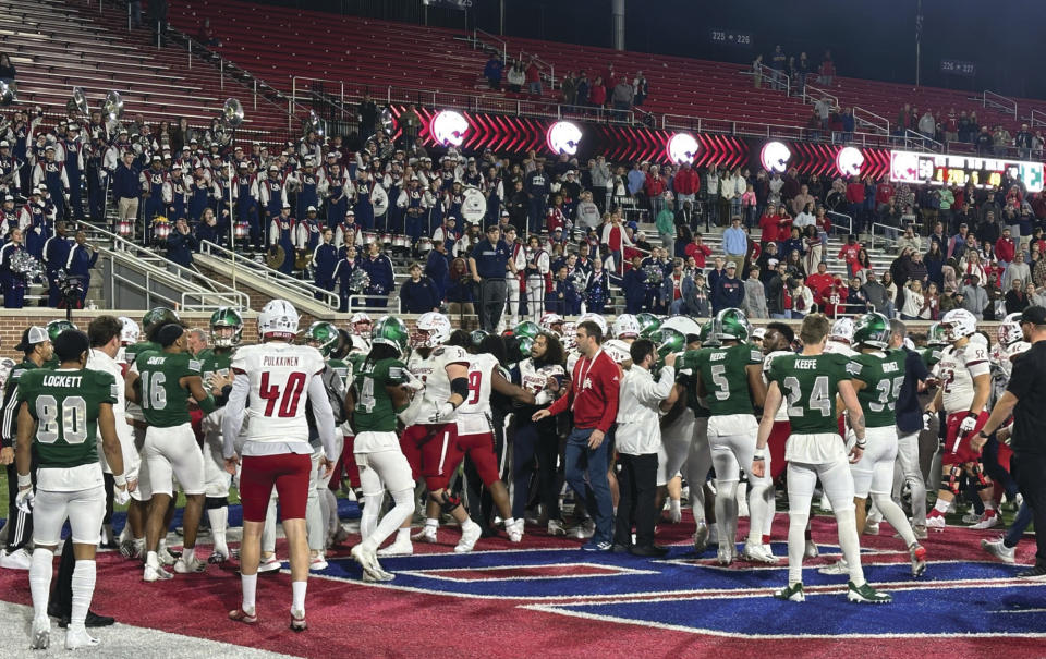 People react to a brawl that ensued following the NCAA College Football 68 Ventures Bowl between South Alabama and Eastern Michigan on Saturday, Dec. 23, 2023, in Mobile, Ala. Eastern Michigan took responsibility after video review of the incident. (Hunter Dawkins/The Gazebo Gazette via AP)