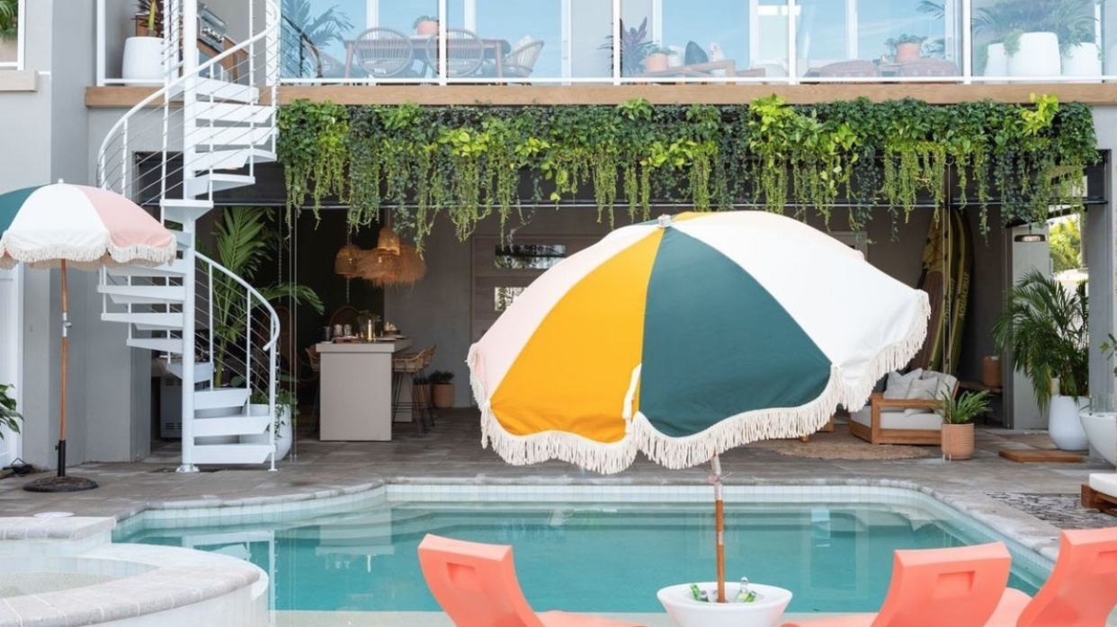 a pool with a yellow umbrella