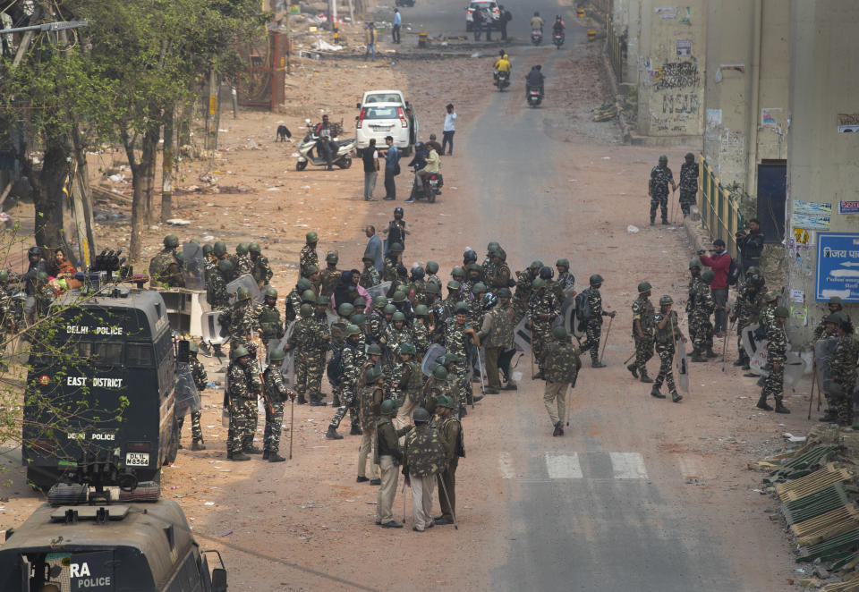 Indian Paramilitary soldiers stand guard in an area that saw violence on Tuesday in New Delhi, India, Wednesday, Feb. 26, 2020. At least 20 people were killed in three days of clashes in New Delhi, with the death toll expected to rise as hospitals were overflowed with dozens of injured people, authorities said Wednesday. The clashes between Hindu mobs and Muslims protesting a contentious new citizenship law that fast-tracks naturalization for foreign-born religious minorities of all major faiths in South Asia except Islam escalated Tuesday. (AP Photo/Rajesh Kumar Singh)