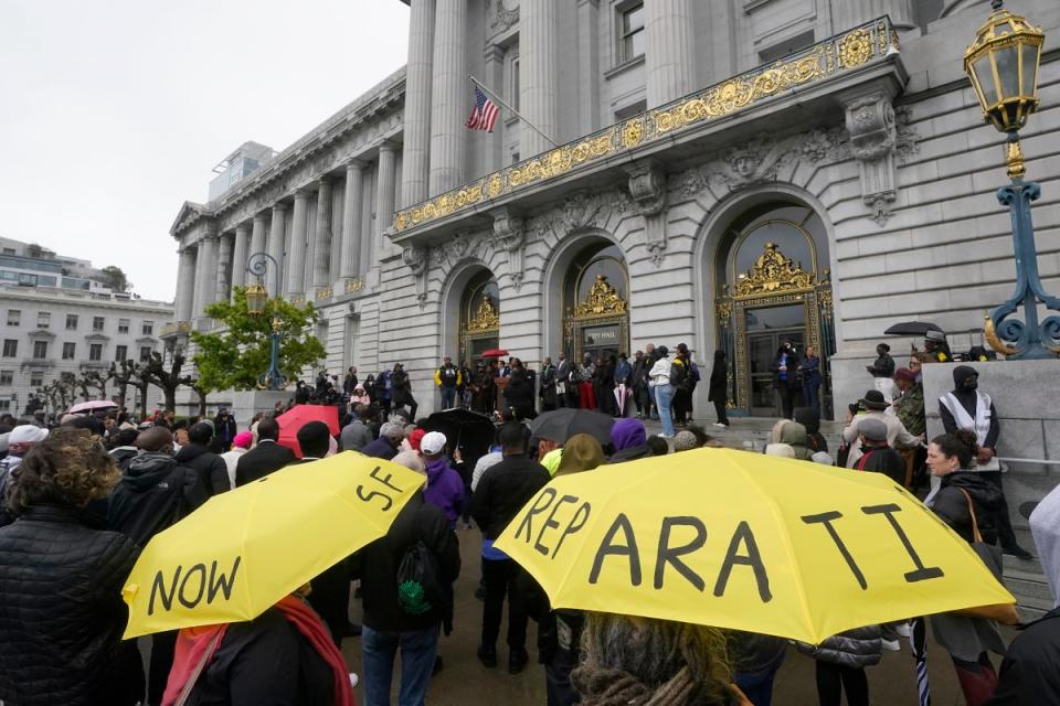 A crowd listens to speakers at a reparations rally outside of City Hall in San Francisco on 14 March 2023 (AP)