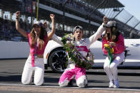 Helio Castroneves, of Brazil, celebrates winning the Indianapolis 500 auto race at Indianapolis Motor Speedway with Adriana Henao, left, and Mikaella Castroneves, Sunday, May 30, 2021, in Indianapolis. (AP Photo/Darron Cummings)