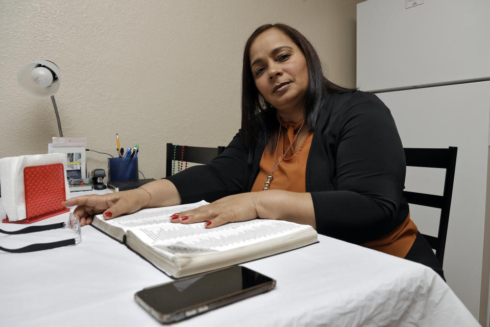 In this Wednesday, Feb. 26, 2020 photo, Yarelis Gutierrez Barrios poses for a photo at her home in Tampa, Fla. Her partner Roylan Hernandez Diaz, a Cuban asylum seeker, hanged himself in a Louisiana prison last October. An Associated Press investigation into Hernandez’s death found neglect and apparent violations of government policies by jailers under U.S. Immigration and Customs Enforcement. (AP Photo/Chris O'Meara)