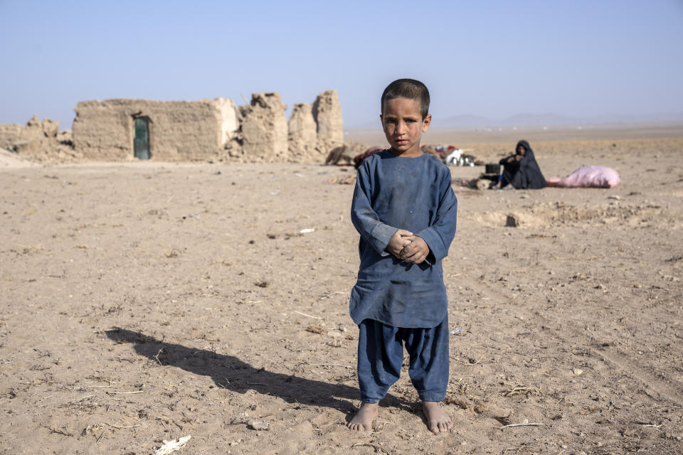 An Afghan boy stands in front of his house that was destroyed by the earthquake in Zenda Jan district in Herat province, western Afghanistan, Wednesday, Oct. 11, 2023. Another strong earthquake shook western Afghanistan on Wednesday morning after an earlier one killed more than 2,000 people and flattened whole villages in Herat province in what was one of the most destructive quakes in the country's recent history. (AP Photo/Ebrahim Noroozi)