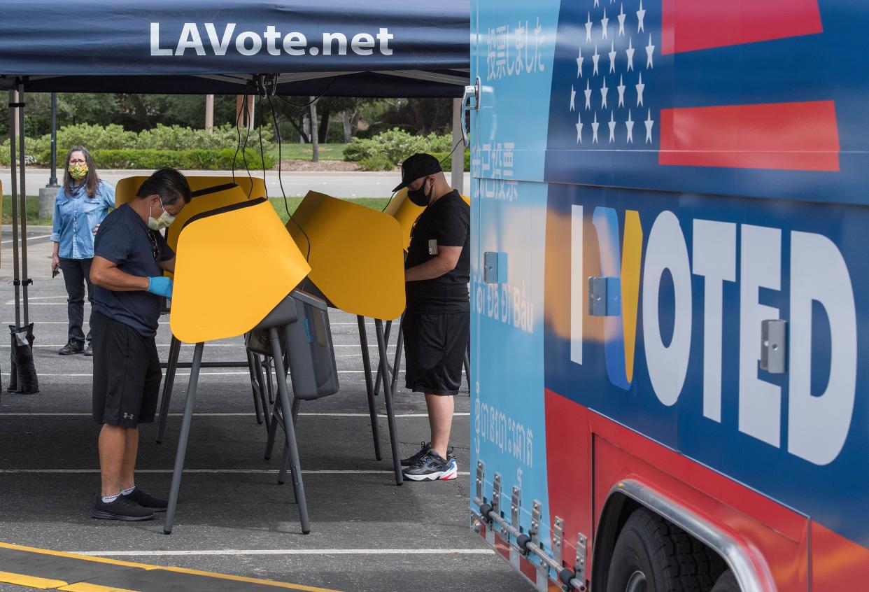 People vote at a voting station for the special election between Democratic state assemblywoman Christy Smith and Republican businessman and ex-Navy pilot Mike Garcia to replace former Democratic Congresswoman Katie Hill in the state's 25th Congressional District in Santa Clarita, Calif. on May 12, 2020. The polling place was set up to encourage social distancing during the election, which is taking place amid the coronavirus pandemic.