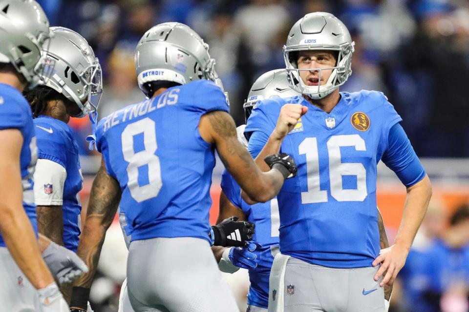 Detroit Lions quarterback Jared Goff fist bumps teammates during warmups before the game against the Green Bay Packers at Ford Field in Detroit on Thursday, Nov. 23, 2023.