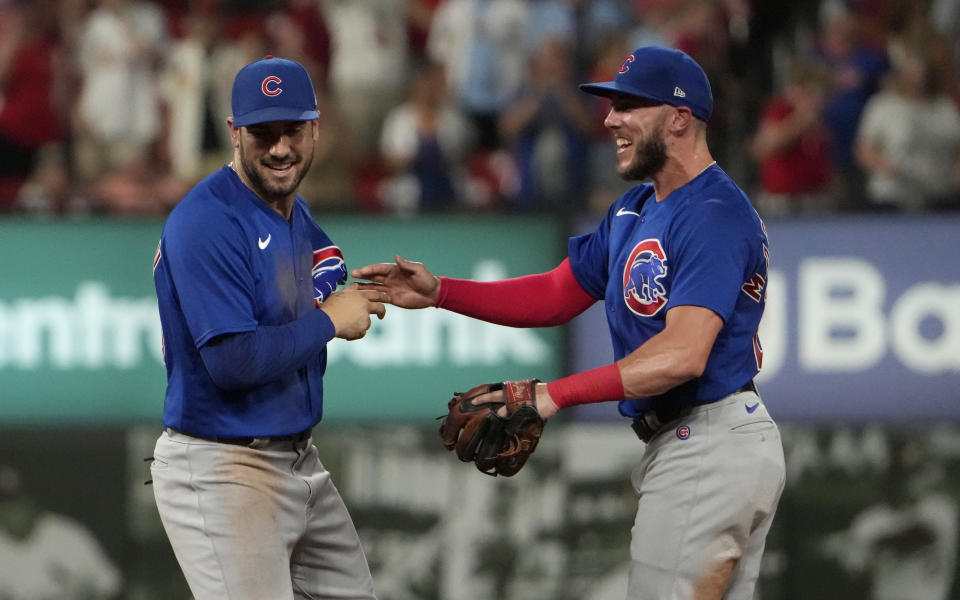 Chicago Cubs' Mike Tauchman, left, is congratulated by teammate Miles Mastrobuoni after making a catch at the wall on a fly ball by St. Louis Cardinals' Alec Burleson to end a baseball game Friday, July 28, 2023, in St. Louis. The Cubs won 3-2. (AP Photo/Jeff Roberson)