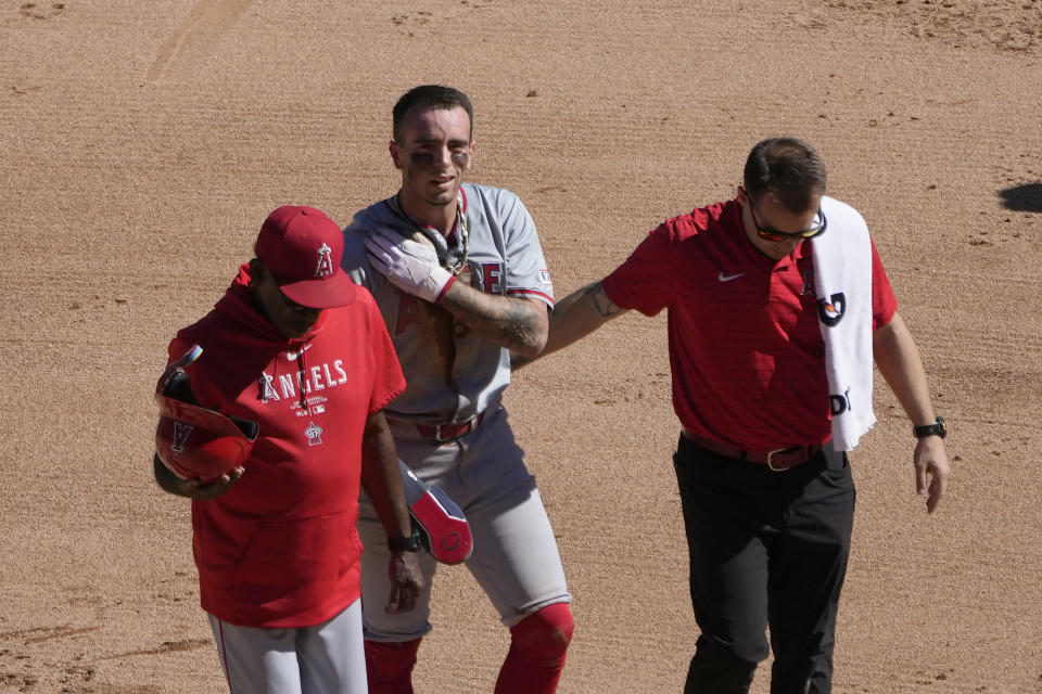 Los Angeles Angels' Zach Neto holds his shoulder as he heads to the dugout after being caught trying to steal second during the fourth inning of a baseball game against the Chicago White Sox on Thursday, Sept. 26, 2024, in Chicago. (AP Photo/Charles Rex Arbogast)