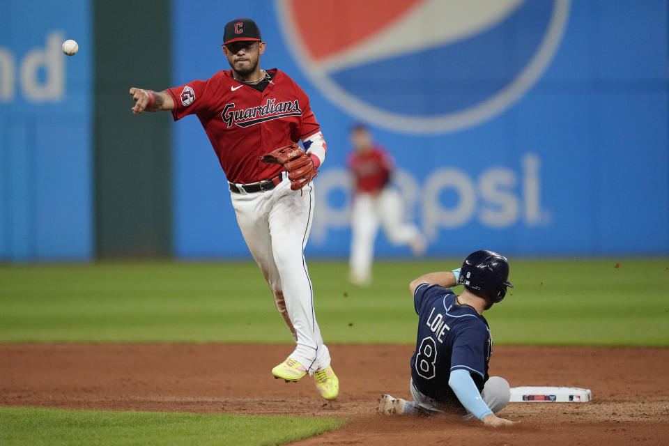 Cleveland Guardians right fielder Gabriel Arias, left, forces out Tampa Bay Rays' Brandon Lowe (8) at second base and completes the throw to first base for a double play against Josh Lowe in the eighth inning of a baseball game Saturday, Sept. 2, 2023, in Cleveland. (AP Photo/Sue Ogrocki)