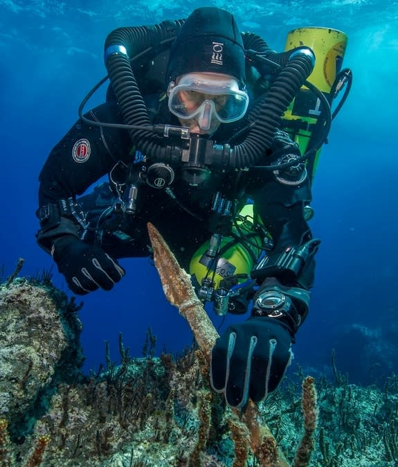 Project chief diver of the "Return to Antikythera" mission, Philip Short examines a bronze spear removed from the ancient Greek shipwreck.