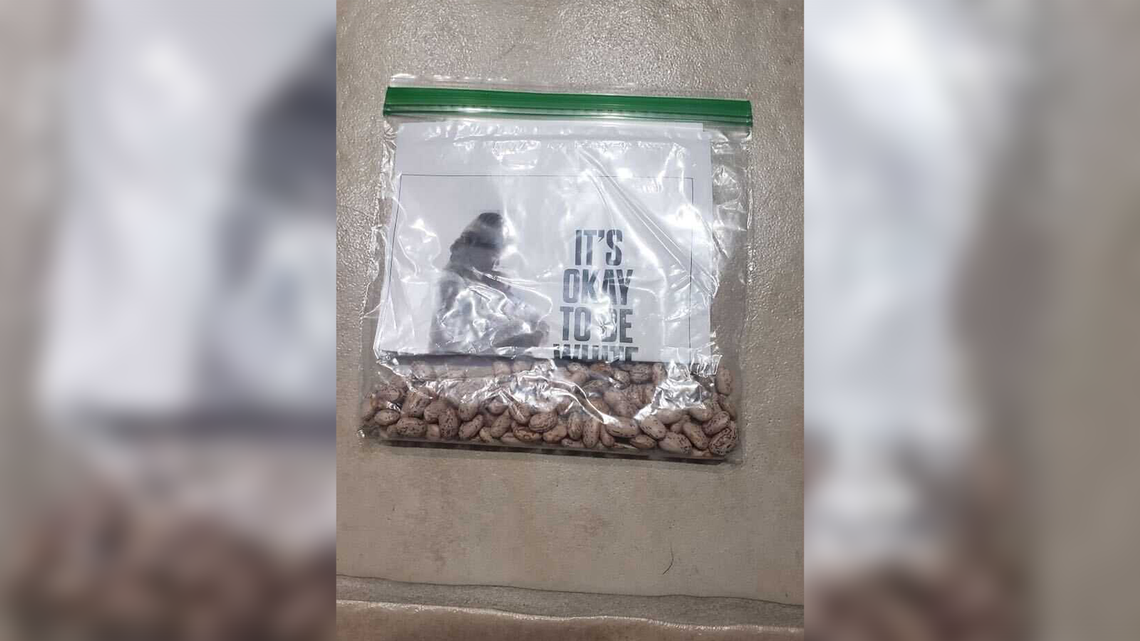 Flyers that said, “It’s okay to be white,” and provided a link to a white supremacist organization were folded in half and placed in a plastic bag that contained pinto beans on the sidewalks and driveways of Callander Way on Friday, Jan. 27, 2023. A resident said that the four flyers they saw were on driveways of houses occupied by persons of color.