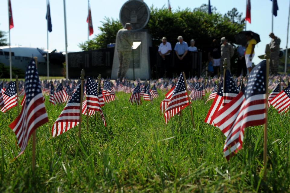 Chaplain (Capt.) John Weeks, a 19th Airlift Wing chaplain, and Team Little Rock members pray during the base's National Flag Day ceremony June 14, 2013, at Little Rock Air Force Base, Ark. On National Flag Day different organizations hold parades to celebrate the Nation's Flag. (U.S. Air Force photo by Senior Airman Rusty Frank)