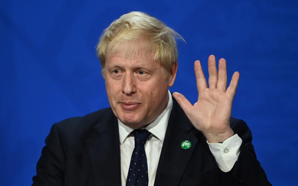 Britain's Prime Minister Boris Johnson speaks at a press conference in Downing Street in London, Britain. Boris Johnson wears a suit and tie, and holds up his left hand as he speaks.  -  NEIL HALL/POOL/EPA-EFE/Shutterstoc/Shutterstock