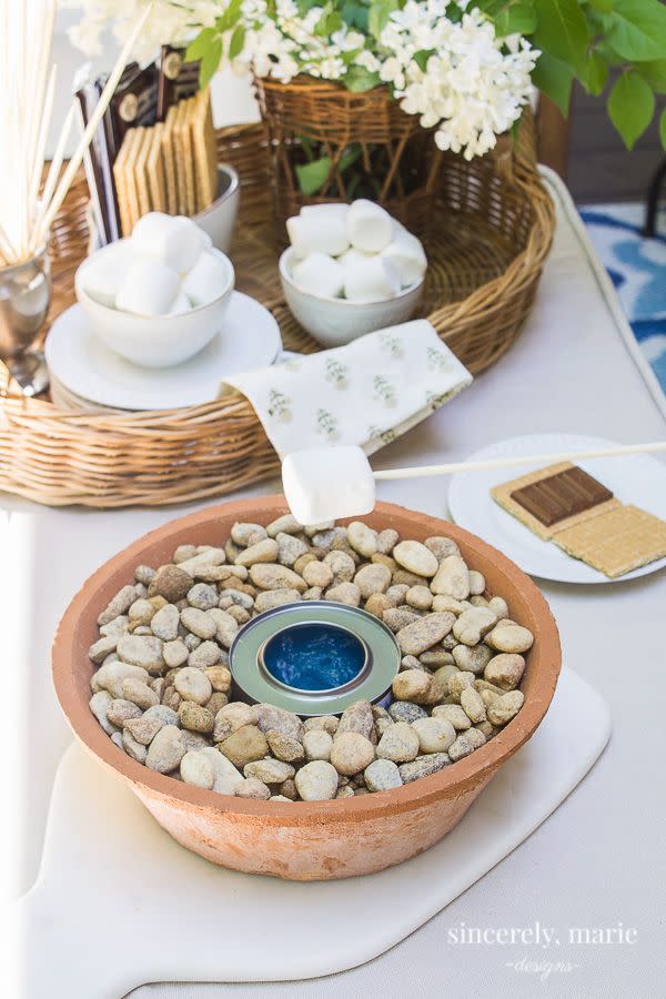 <p>Made specifically for s'mores-loving families, this sweet little table top burner can be used when the weather is too warm for the fire pit.</p><p><strong>Get the tutorial at <a href="https://sincerelymariedesigns.com/diy-tabletop-marshmallow-roaster/" rel="nofollow noopener" target="_blank" data-ylk="slk:Sincerely, Marie Designs;elm:context_link;itc:0;sec:content-canvas" class="link ">Sincerely, Marie Designs</a>.</strong></p><p><a class="link " href="https://www.amazon.com/Royal-Imports-Decorative-Ornamental-Landscaping/dp/B0143IX8W6/?tag=syn-yahoo-20&ascsubtag=%5Bartid%7C10050.g.31966151%5Bsrc%7Cyahoo-us" rel="nofollow noopener" target="_blank" data-ylk="slk:SHOP RIVER ROCKS;elm:context_link;itc:0;sec:content-canvas">SHOP RIVER ROCKS</a></p>