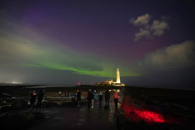 The aurora borealis, also known as the northern lights, glow on the horizon at St Mary's Lighthouse in Whitley Bay on the North East coast, March 23, 2023.