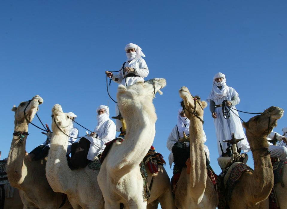 FILE - In this Dec. 12, 2002 file photo Tuaregs are shown on their camels outside Ghardaia, southern Algeria. The awe-inspiring dunes and wild mountains of Algeria’s Sahara have lured adventure travelers for decades, but their latest incarnation _ as a crossroad for the al-Qaida militants who attacked a natural gas complex _ is likely to make them even more inaccessible. (AP Photo/Laurent Rebours, file)