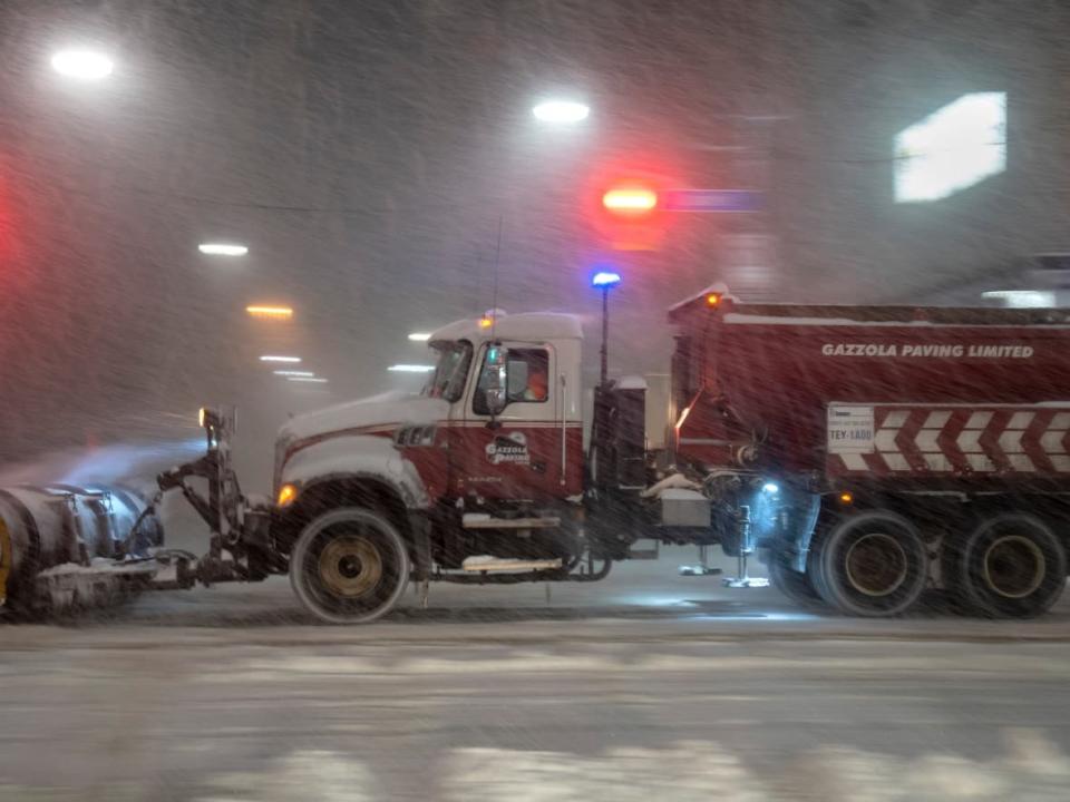 A snowplow clears streets during a winter storm in Toronto on Monday. (Frank Gunn/The Canadian Press - image credit)