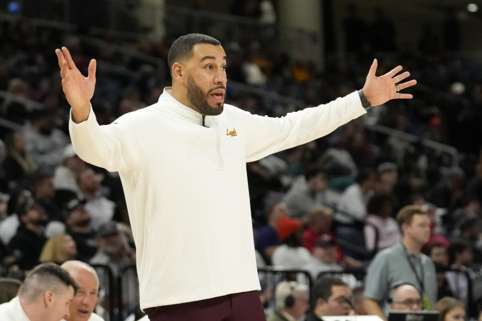 FILE - Loyola head coach Drew Valentine directs his team during an NCAA college basketball game against Florida Atlantic Wednesday, Nov. 8, 2023, in Chicago. Six years removed from a Final Four run that made a 98-year-old nun a celebrity, Loyola is winning big again. The Ramblers are as hot as any team in the Atlantic 10 and have their sights set on the NCAA Tournament. (AP Photo/Charles Rex Arbogast, File)