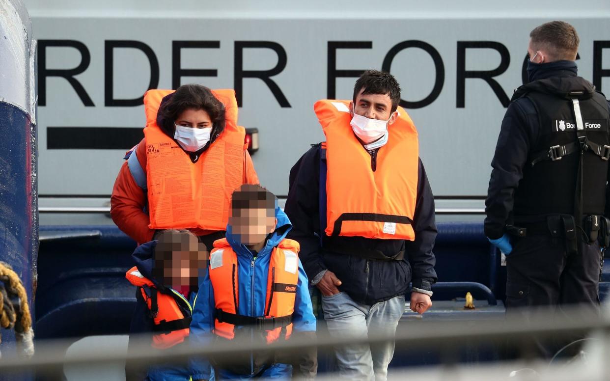 A young family amongst a group of people thought to be migrants are brought in to Dover, Kent, by Border Force officers following a small boat incident in the Channel. Home Secretary Priti Patel has said she will make "no apology" for tougher immigration rules as she announces "the biggest overhaul of the UK's asylum system in decades". Ms Patel's new plan for immigration, detailing how the Government intends to deal with people entering the UK "illegally", will be set out today. Picture date: Wednesday March 24, 2021. PA Photo. See PA story POLITICS Immigration. Photo credit should read: Gareth Fuller/PA Wire - Gareth Fuller/PA Wire