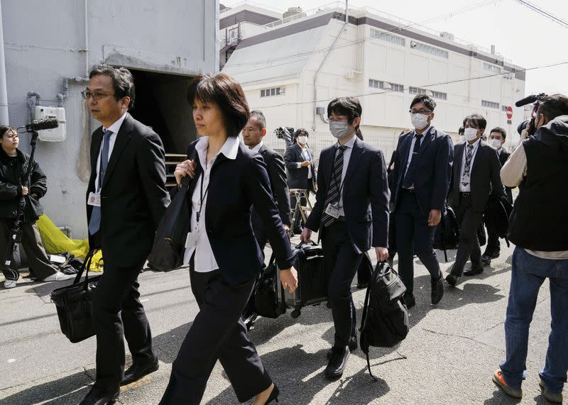 Japanese health ministry officials head to search a Kobayashi Pharmaceutical Co. factory in Osaka