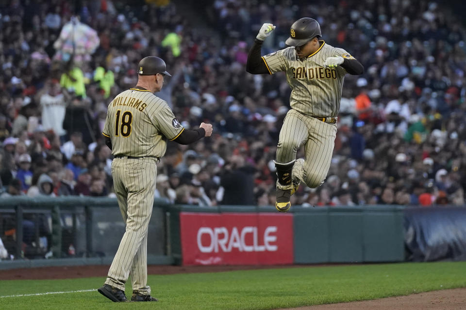 San Diego Padres' Juan Soto, right, is congratulated by third base coach Matt Williams, left, after hitting a home run during the fifth inning of a baseball game against the San Francisco Giants in San Francisco, Monday, June 19, 2023. (AP Photo/Jeff Chiu)