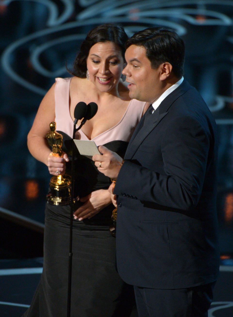 Kristen Anderson-Lopez, left, and Robert Lopez accept the award for an original song in a feature film for "Let It Go" from "Frozen" during the Oscars at the Dolby Theatre on Sunday, March 2, 2014, in Los Angeles. (Photo by John Shearer/Invision/AP)