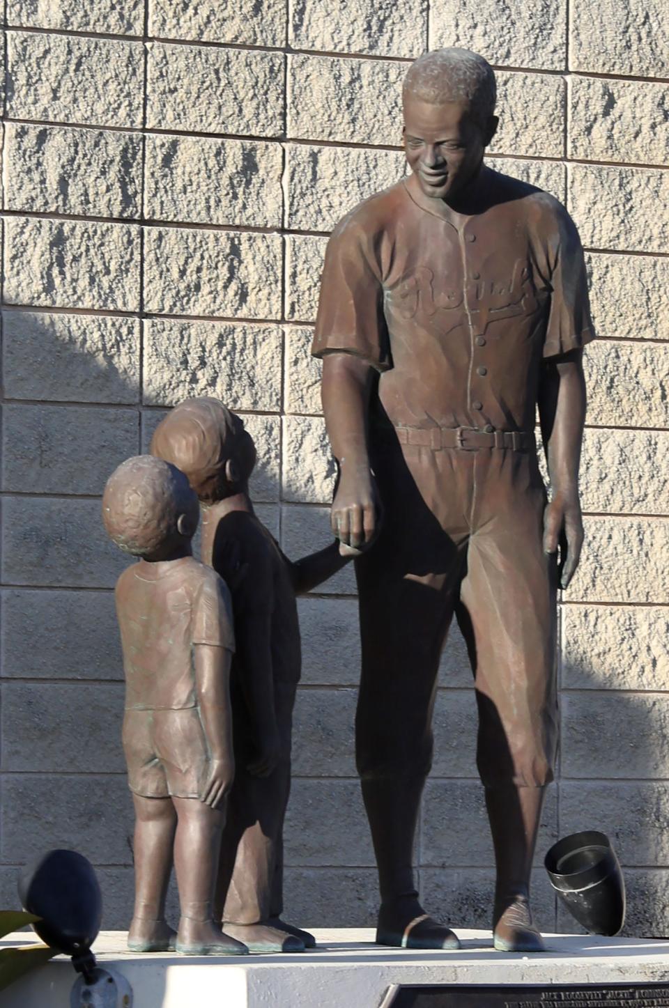 A statue of Jackie Robinson with two young boys at the ballpark named after him, Friday April 12, 2024 in Daytona Beach.