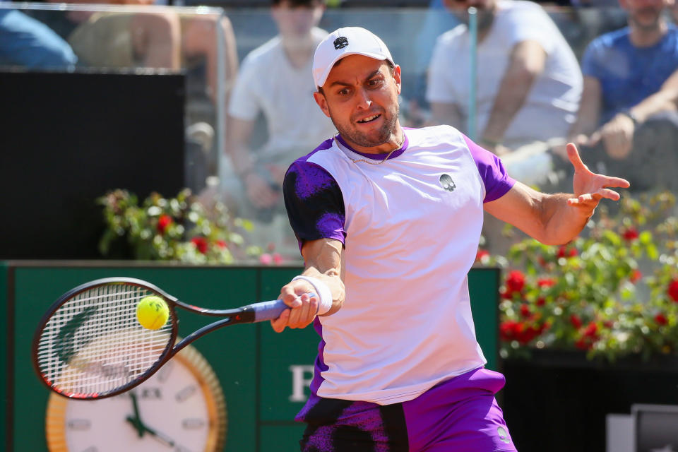 Seen here, Russian Aslan Karatsev plays a forehand against Serbia's Novak Djokovic at the Rome Masters in 2022.