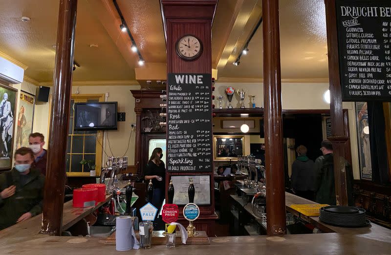 Customers wearing face masks leave a pub in Hackney, London