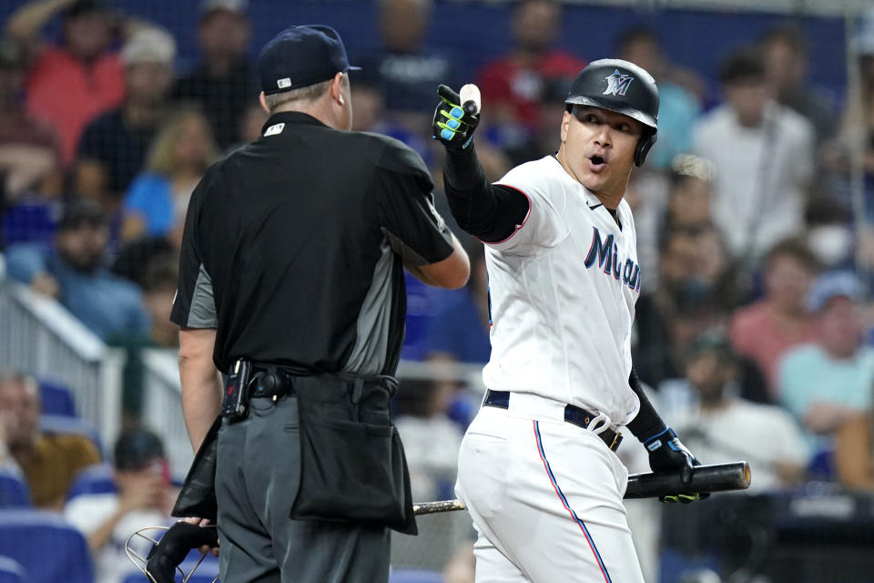 Miami Marlins' Avisail Garcia, right, gestures toward home plate umpire Lance Barrett after bring ejected during the fourth inning of the team's baseball game against the Los Angeles Angels, Tuesday, July 5, 2022, in Miami. (AP Photo/Lynne Sladky)