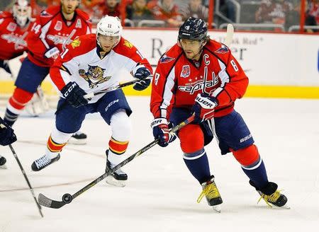 Jan 4, 2015; Washington, DC, USA; Washington Capitals left wing Alex Ovechkin (8) handles the puck as Florida Panthers center Jonathan Huberdeau (11) chases during the first period at Verizon Center. Mandatory Credit: Brad Mills-USA TODAY Sports