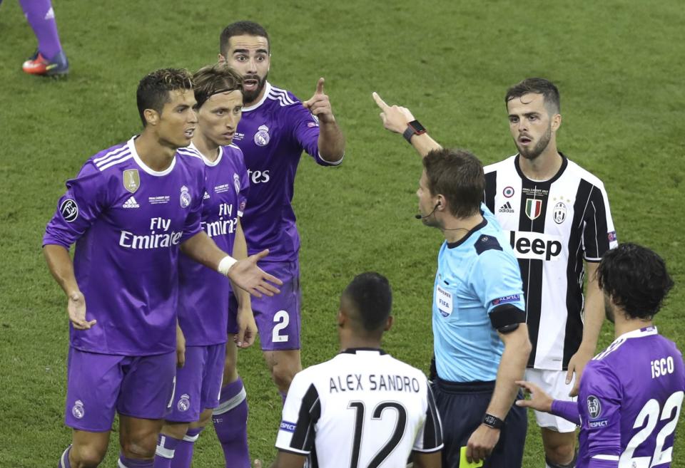 <p>Referee Felix Brych reacts to Real Madrid’s Dani Carvajal during the Champions League Final soccer match between Juventus and Real Madrid at the Millennium Stadium in Cardiff, Wales </p>