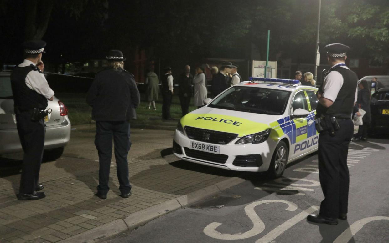 Police officers near to the scene in Deeside Road in Wandsworth - PA