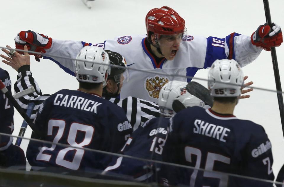 Russia's Pavel Buchnevich celebrates after scoring the winning goal in front of U.S. players in their IIHF Ice Hockey World Championship quarter-final match in Malmo, Sweden, January 2, 2014. REUTERS/Alexander Demianchuk (SWEDEN - Tags: SPORT ICE HOCKEY)