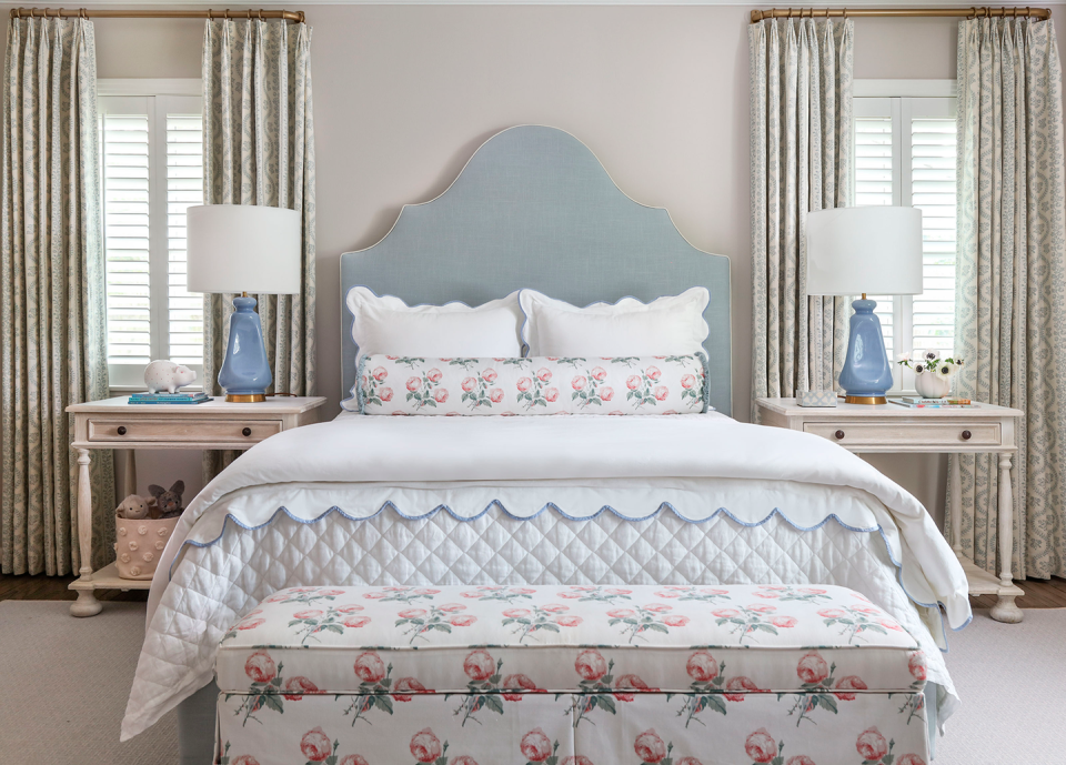 bedroom with blue headboard and floral fabrics