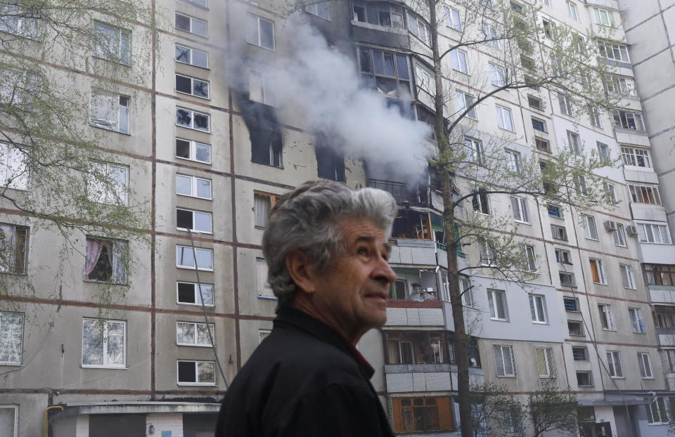 A man reacts next to a burning residential building, following a Russian shelling amid Russia's attack on Ukraine, in Kharkiv, Ukraine, April 25, 2022. / Credit: RICARDO MORAES/REUTERS